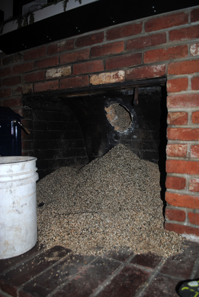 When they pulled the stove and flue out, vermiculite starting pouring out of the hole! This was the insulation around the flue.