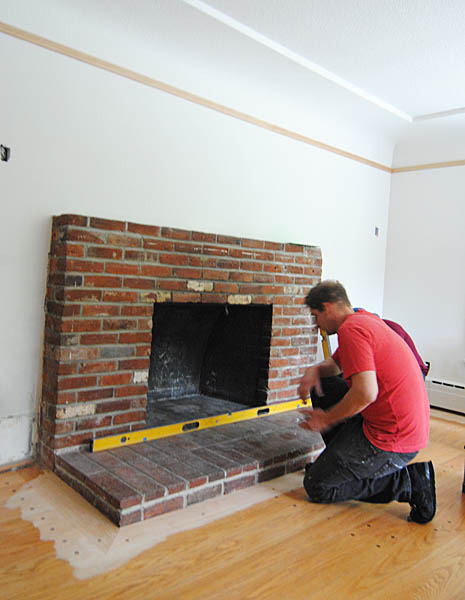 The slab guys measure the existing hearth and check for levelness (it's not level!)