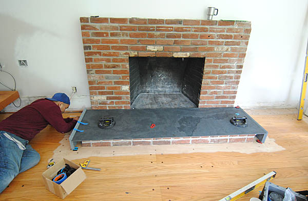 The edges of the slabs are mitered. In this photo, you can see how they install the side piece.
